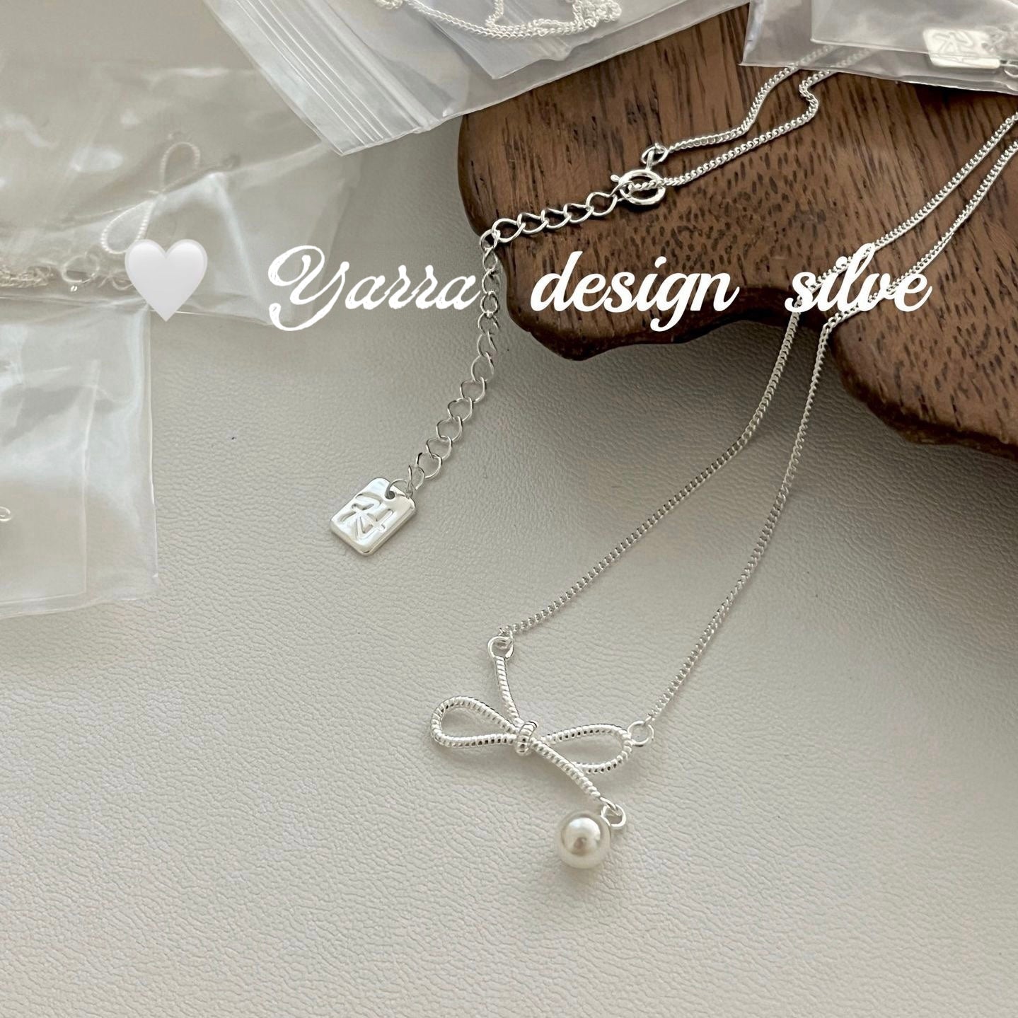Twist Bow & Pearl Pendant Necklace